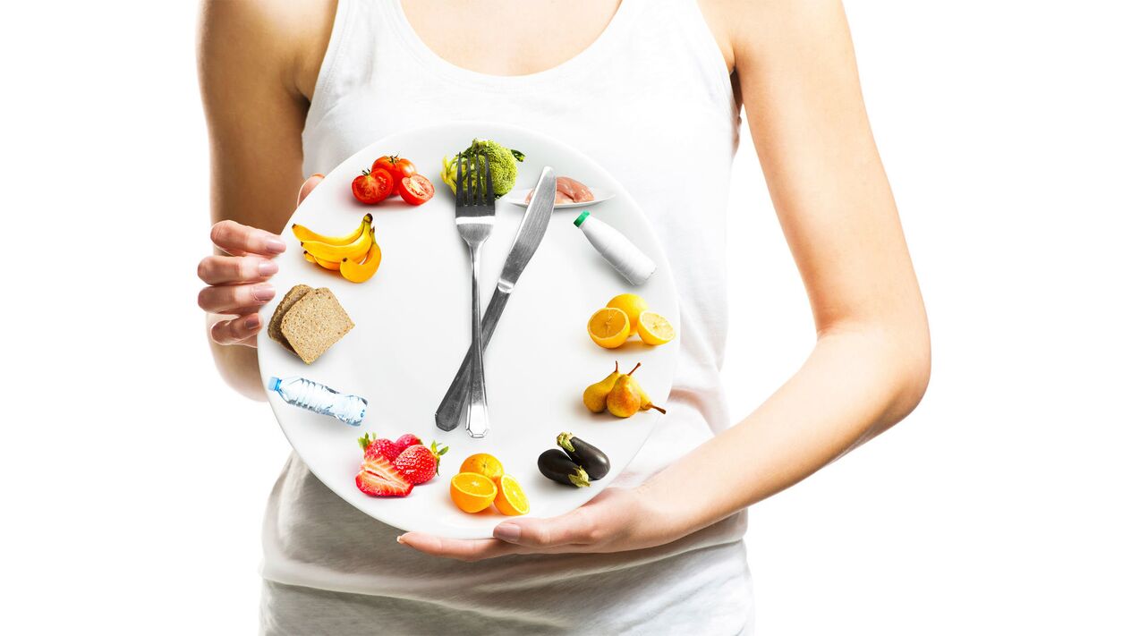 The girl holds a plate of food